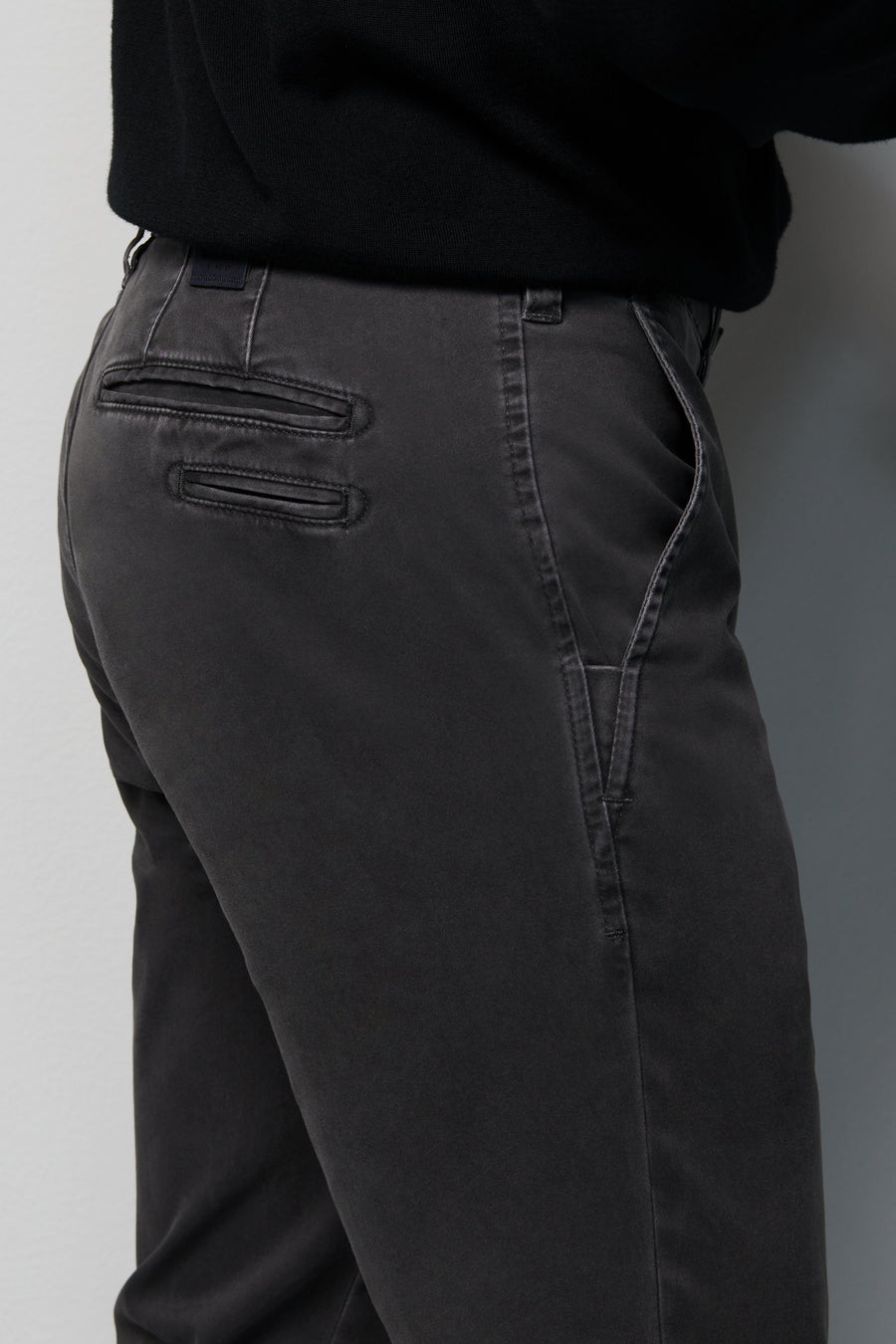 Dark gray pants with a plain background